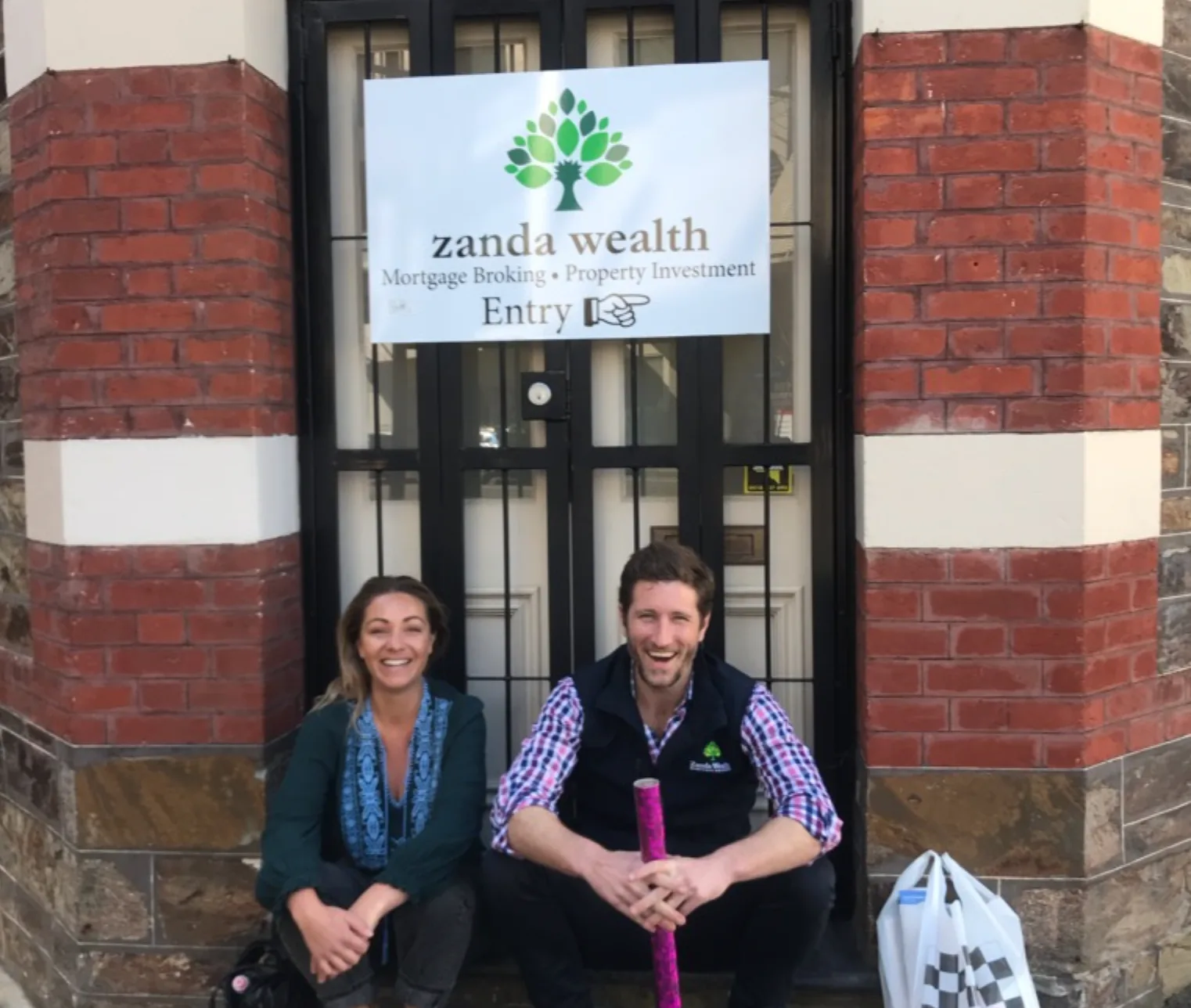 The broking team sitting at the office entrance